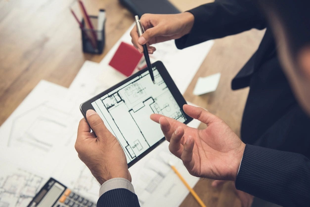 Two people are holding a tablet and pencil.