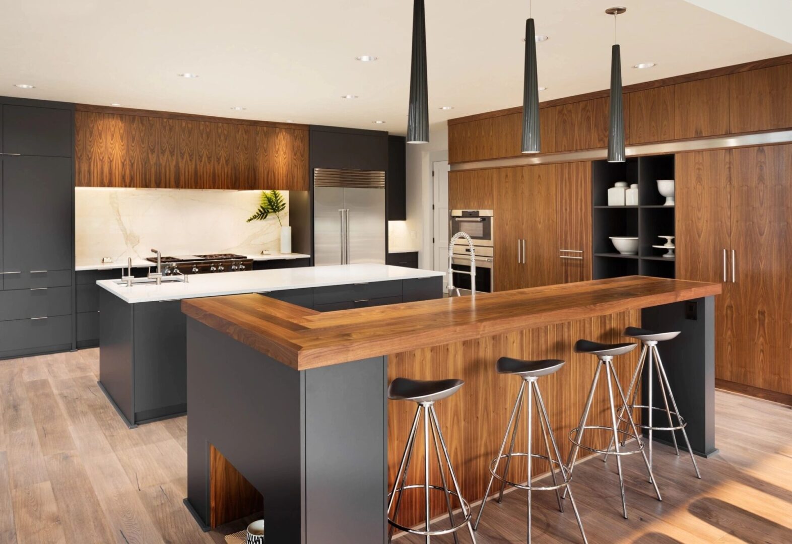 A kitchen with wooden cabinets and black counter tops.