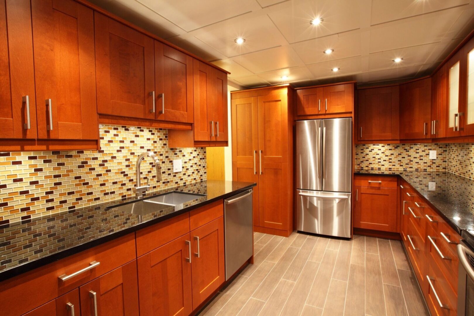 A kitchen with wooden cabinets and stainless steel appliances.