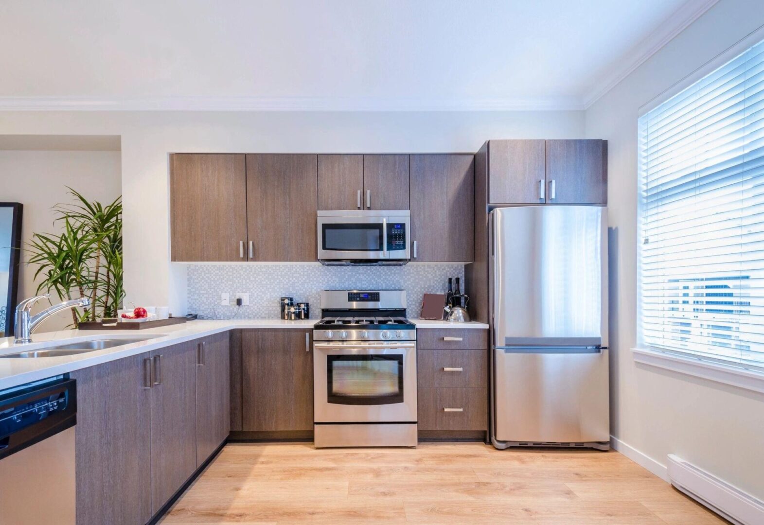 A kitchen with wooden cabinets and stainless steel appliances.