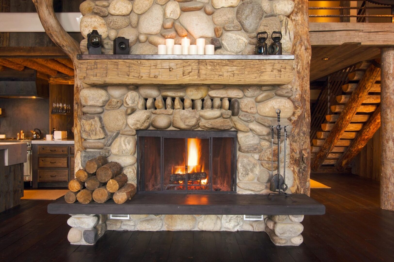 A fireplace with logs and candles in it