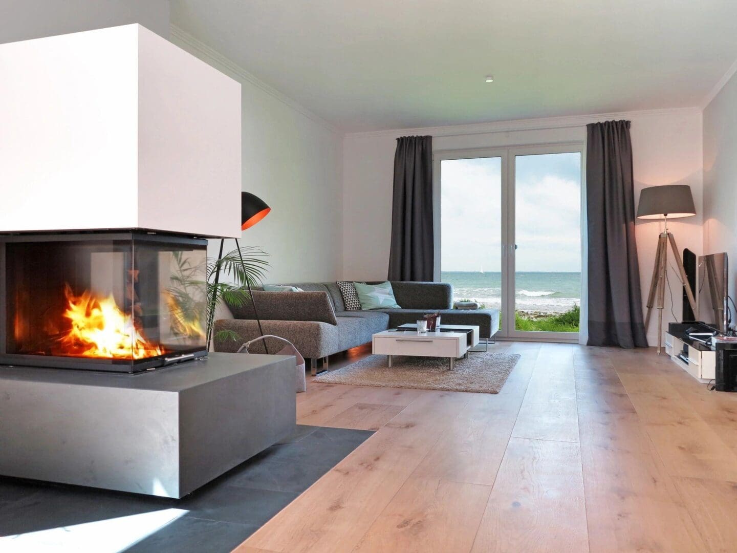 A living room with a fireplace and sliding glass doors.