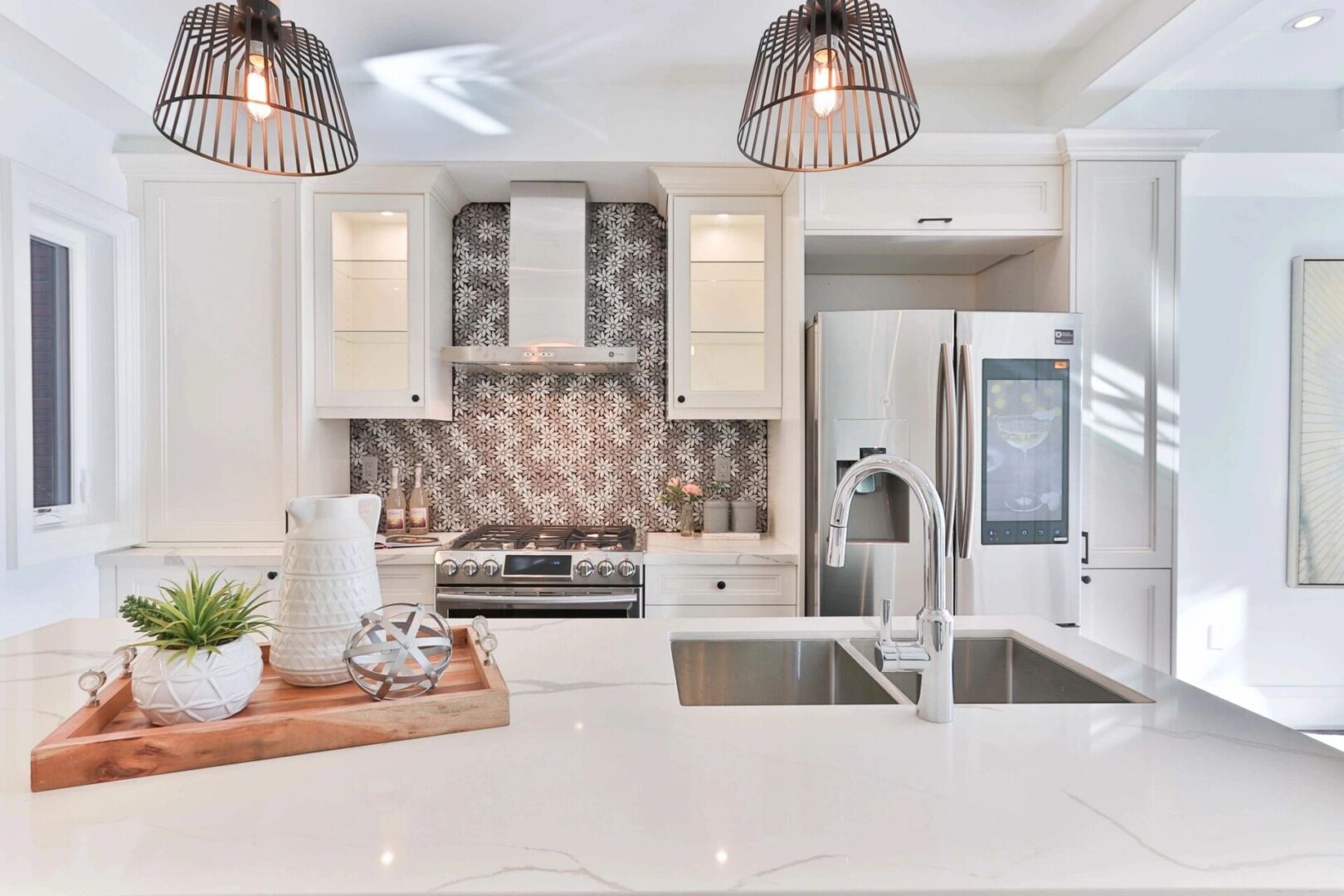 A kitchen with white cabinets and a sink