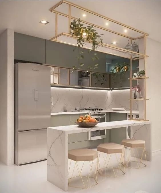 A kitchen with a refrigerator, sink and counter.