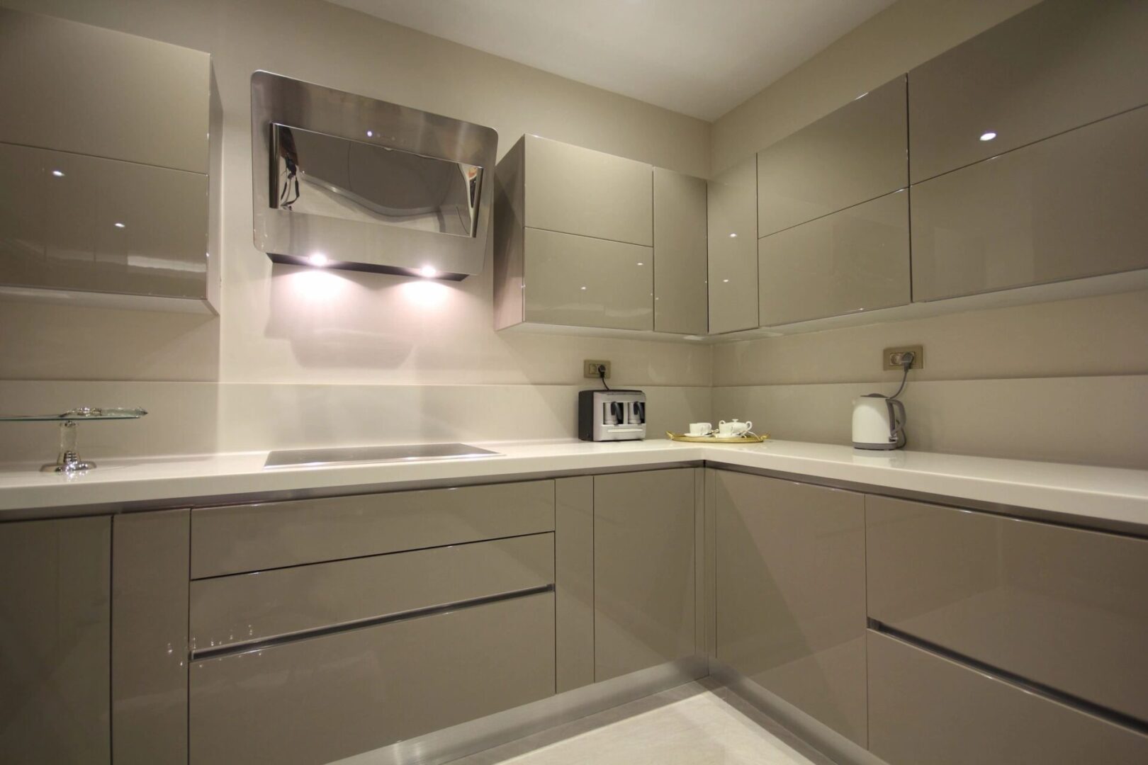 A kitchen with beige cabinets and white counters.