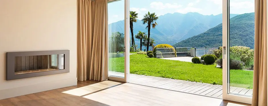 A sliding glass door with a view of the mountains.